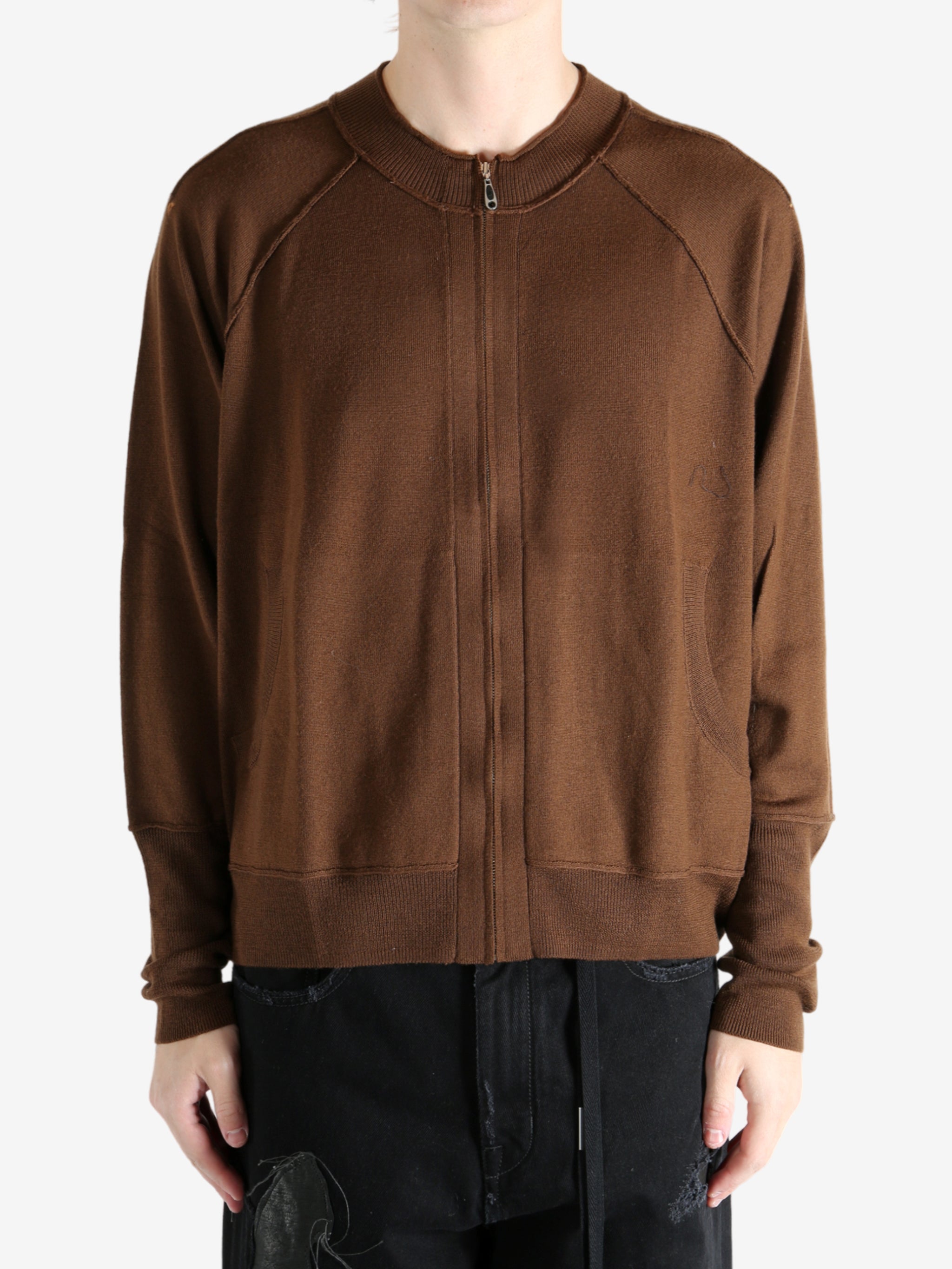 Brown cardigan worn by a person, showing the cardigan's fit