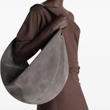 grey bags worn by a person, showing the bags fit