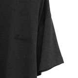 Close up of the black t-shirt, showing texture of the cotton fabric