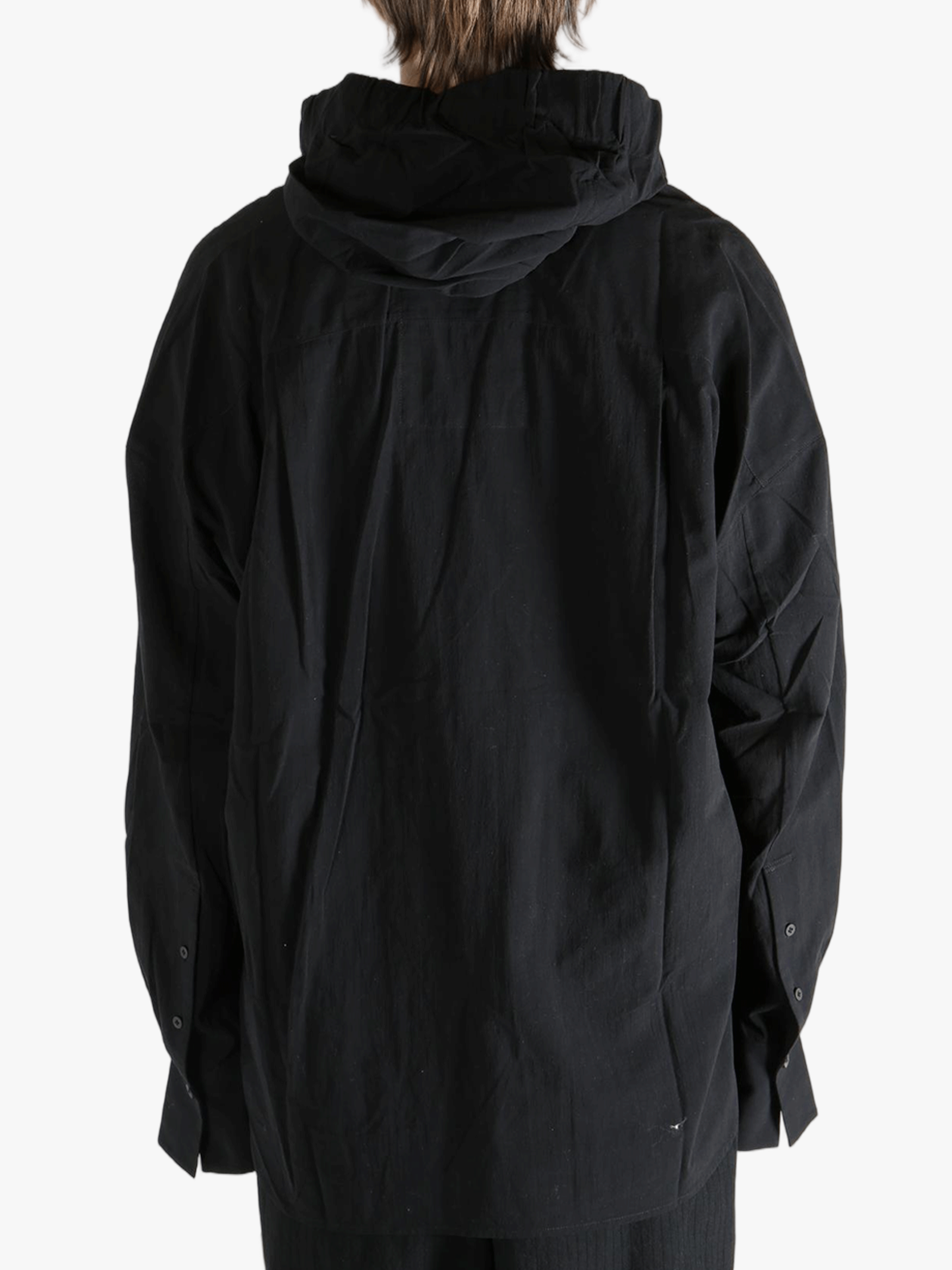 Black shirt worn by a person, showing the shirt's fit