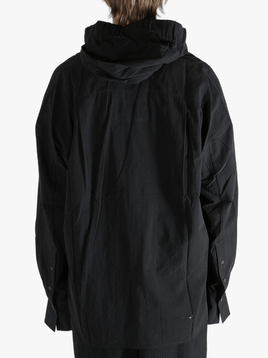 Black shirt worn by a person, showing the shirt's fit