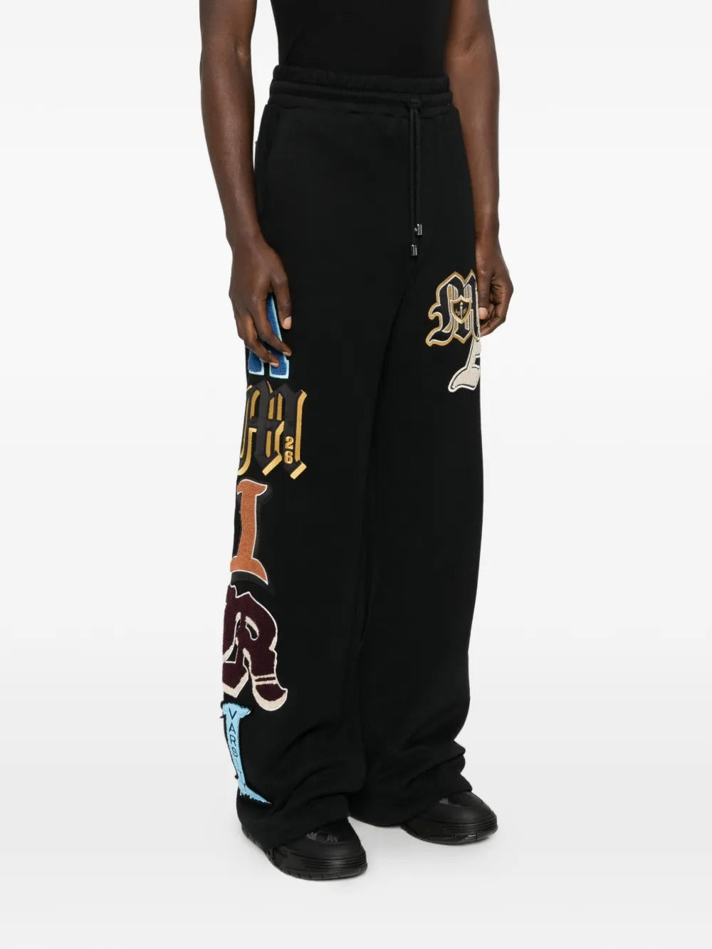 Black pant worn by a person, showing the pant's fit