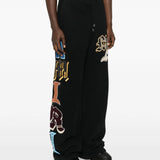 Black pant worn by a person, showing the pant's fit