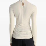 White top worn by a person, showing the top's fit