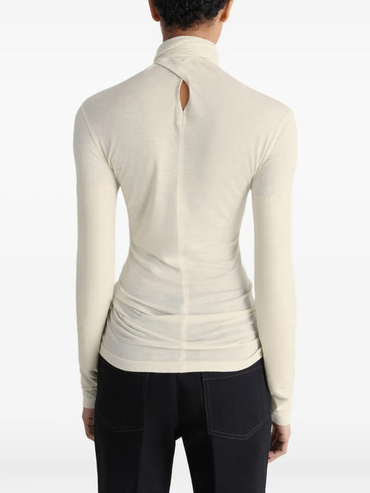 White top worn by a person, showing the top's fit