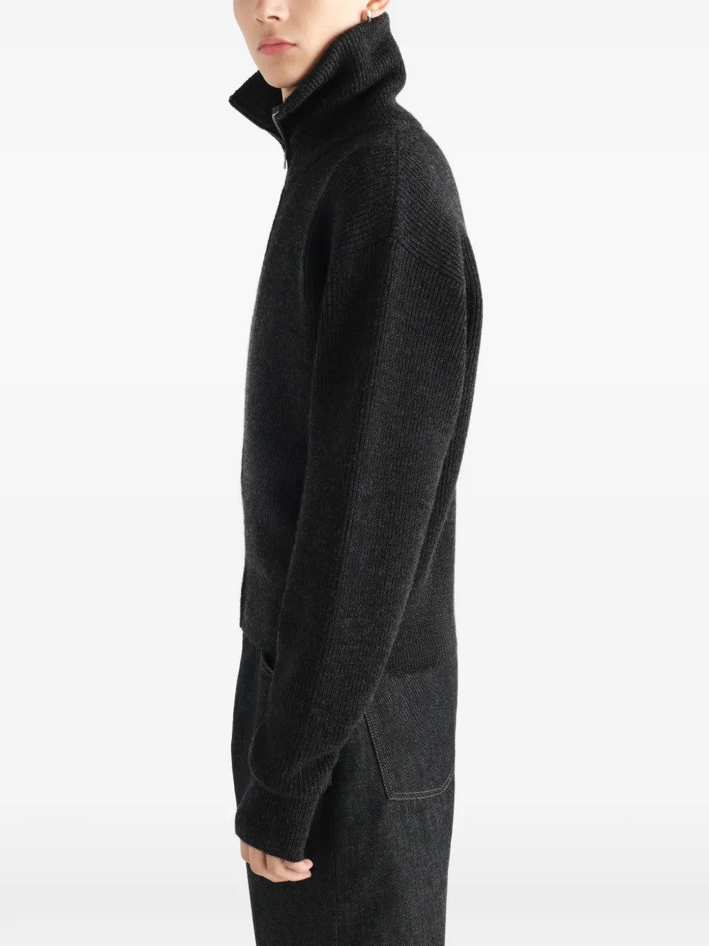 Black knitwear worn by a person, showing the knitwear fit