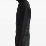 Black knitwear worn by a person, showing the knitwear fit