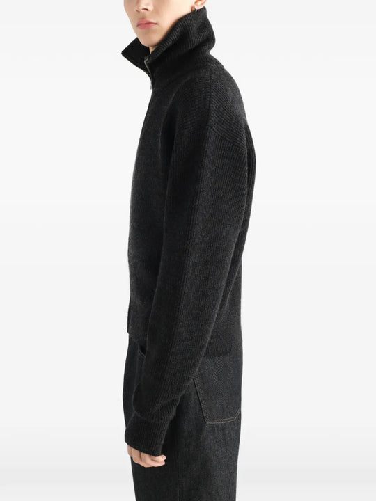 Black knitwear worn by a person, showing the knitwear fit