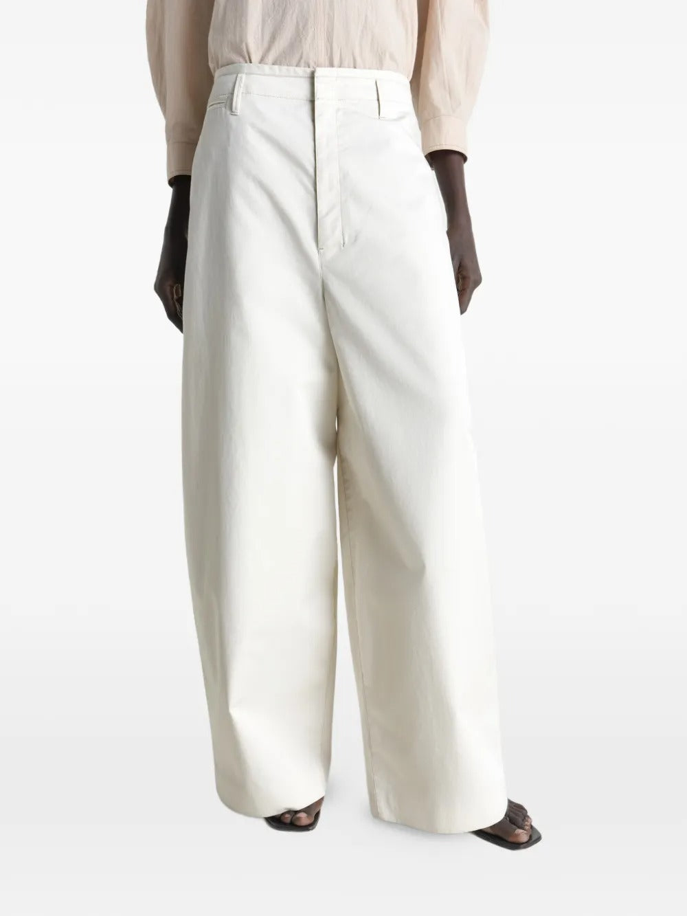 White pants worn by a person, showing the pants fit