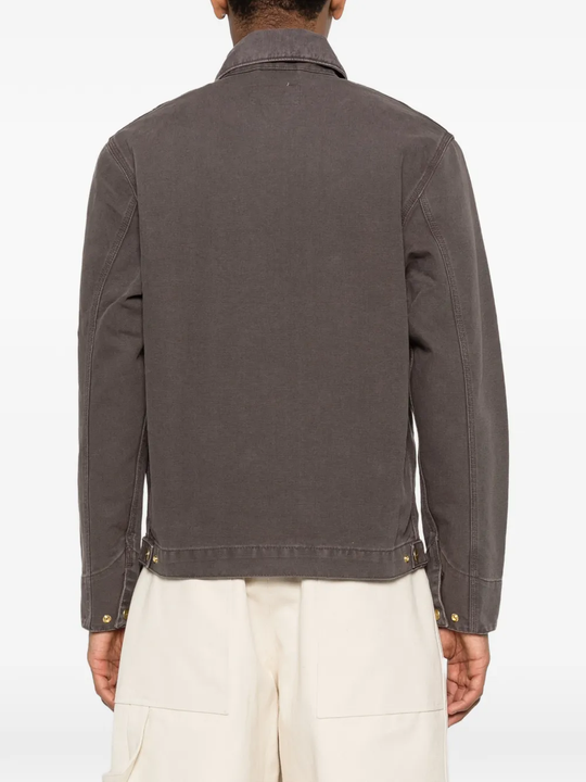 Brown jacket worn by a person, showing the jacket's fit