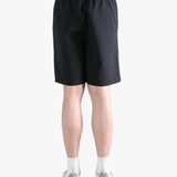 Black short worn by a person, showing the short's fit