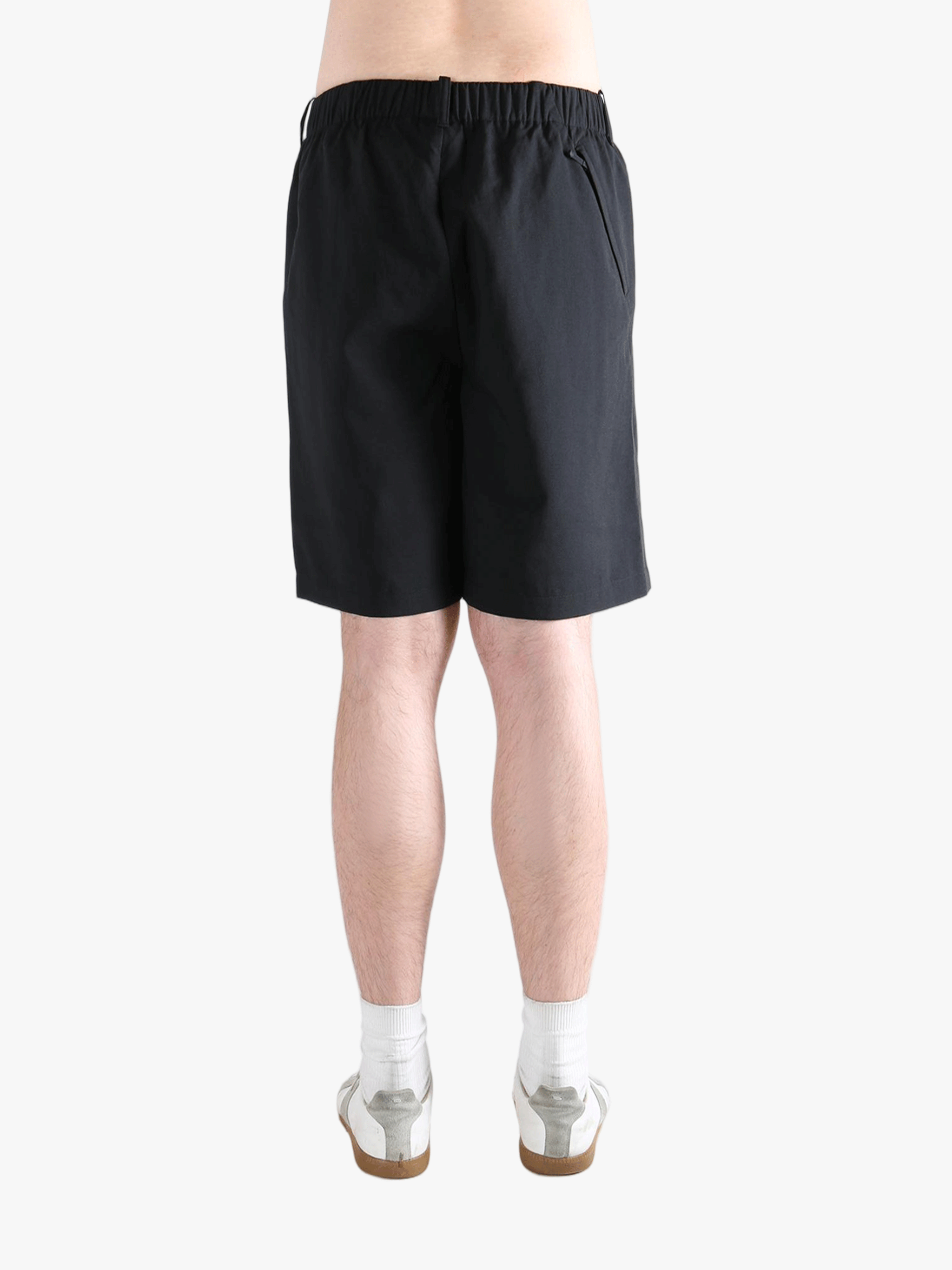 Black short worn by a person, showing the short's fit