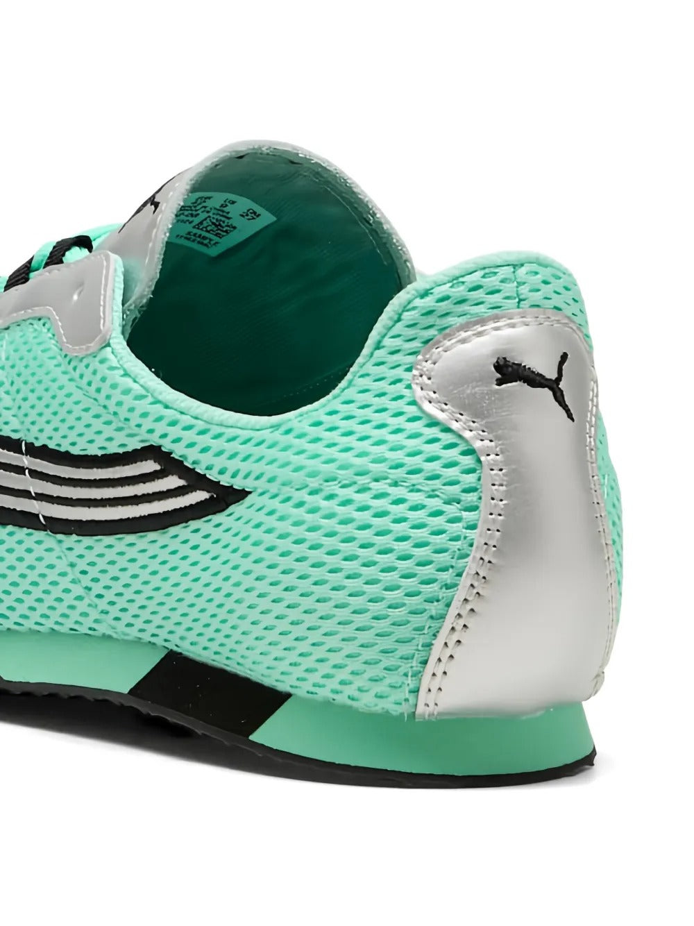 Close-up of green sneaker, showing texture of the mesh fabirc