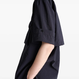 Black shirt worn by a person, showing the shirt's fit