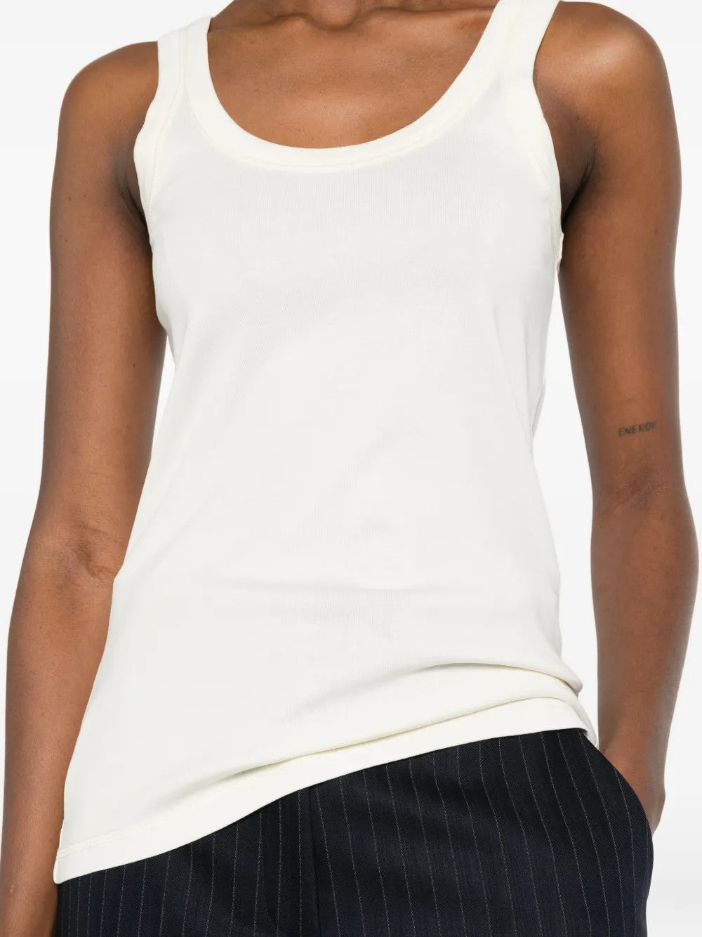 Tan top worn by a person, showing the top fit