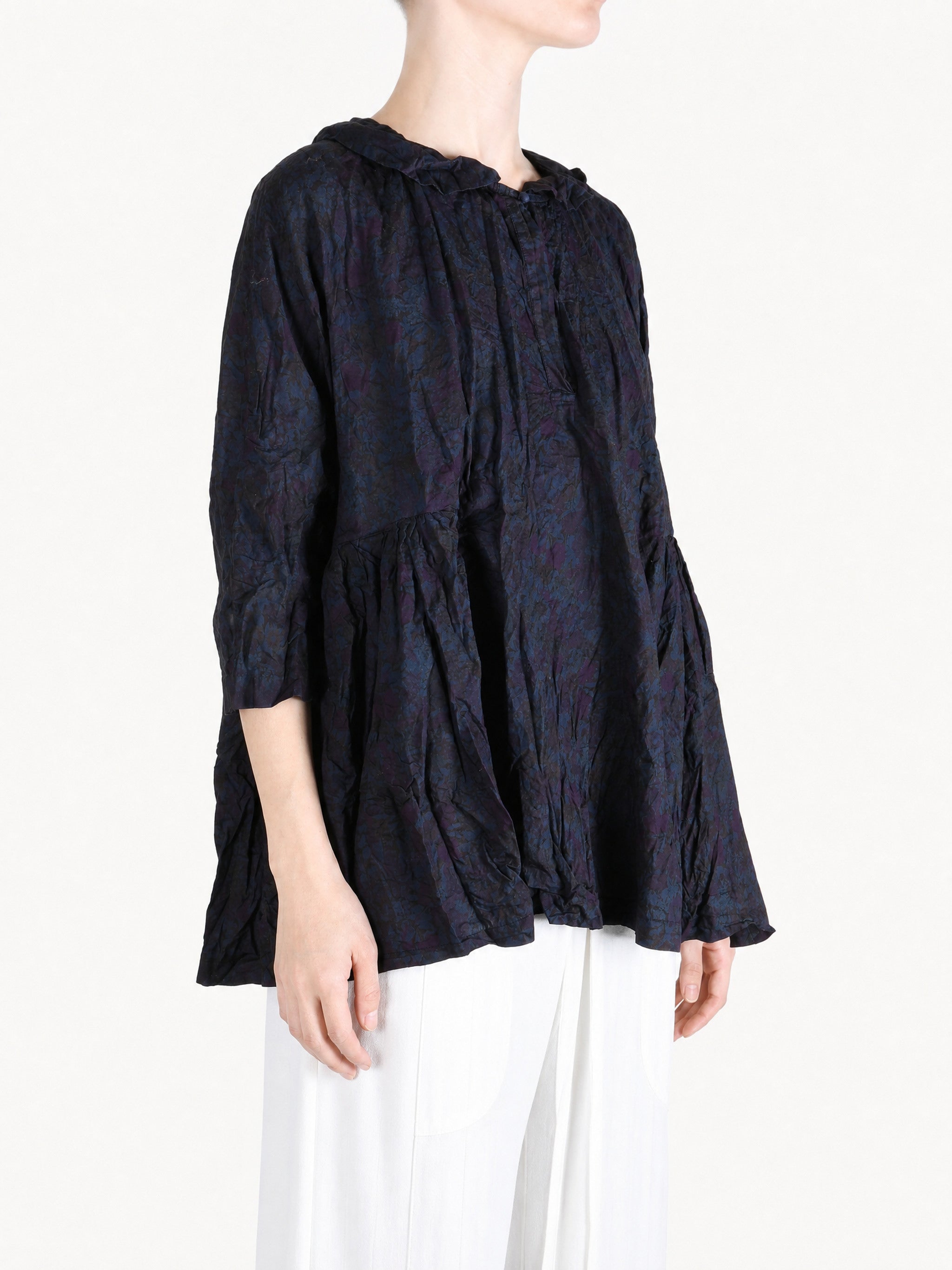 Navy shirt worn by a person, showing the shirt fit