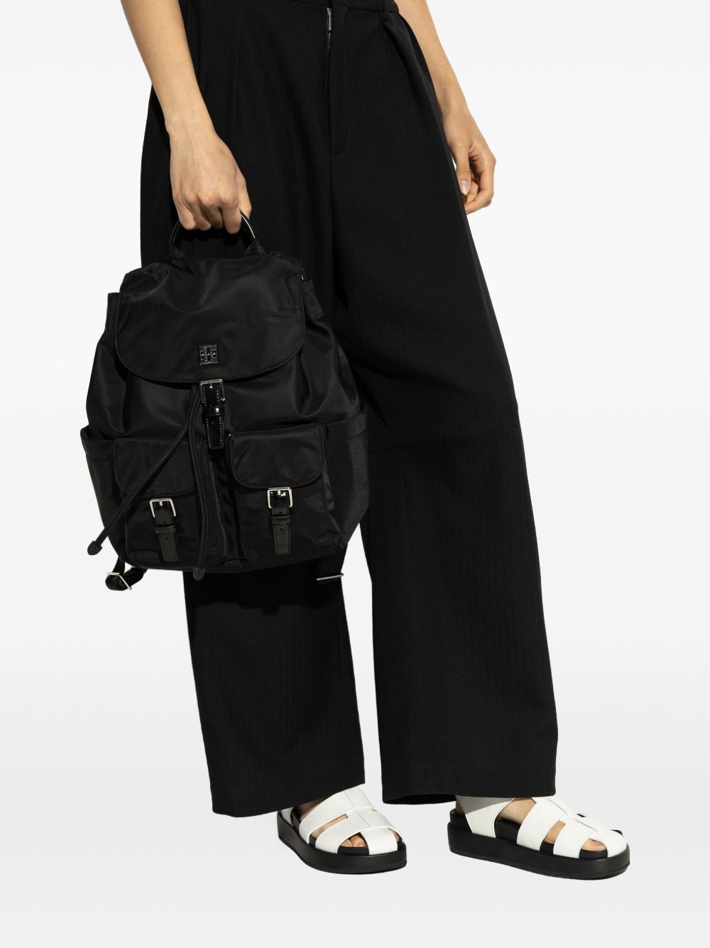 Black bag carried by a person, showing the bag’s fit