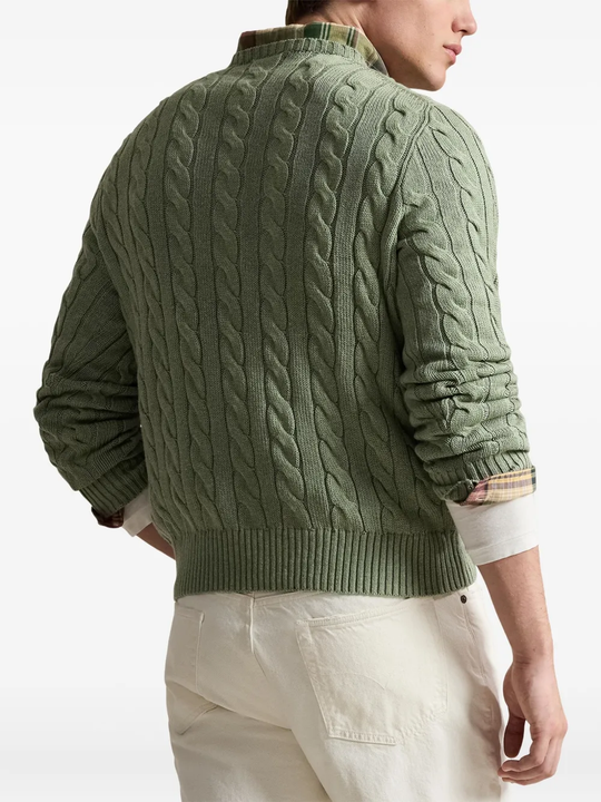Green knitwears,worn by a person, showing the knitwears fit