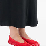 Red flat worn by a person, showing the flats' fit