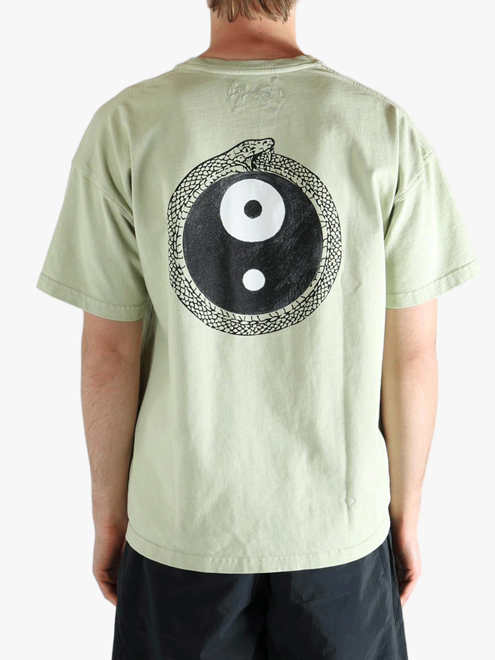 Green t-shirt worn by a person, showing the t-shirt's fit
