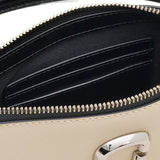Close up of tan bag, showing texture of the leather fabric
