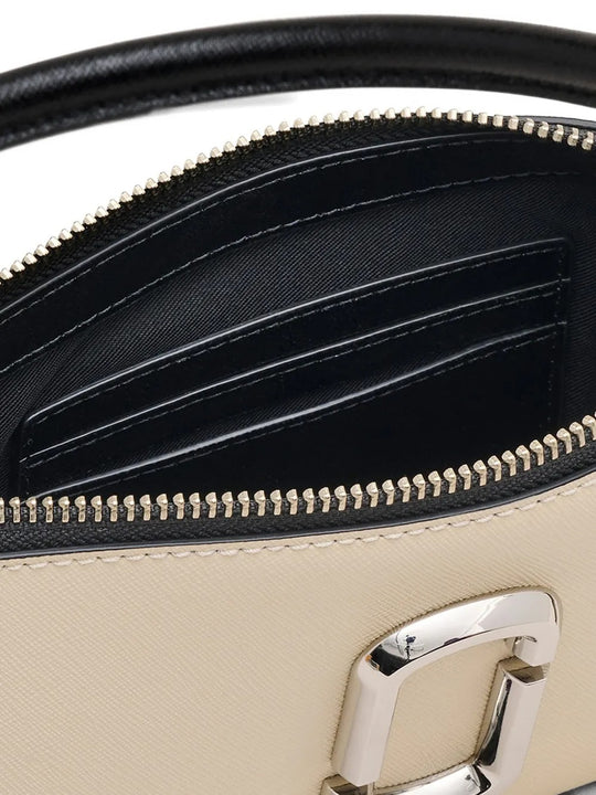 Close up of tan bag, showing texture of the leather fabric