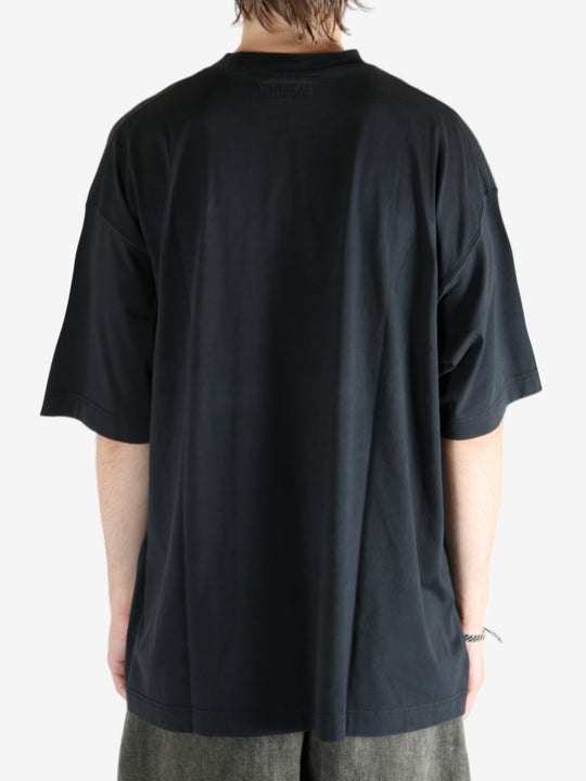 Black shirt worn by a person, showing the shirt fit