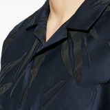 close up of blue shirts, showing texture of the cotton fabric