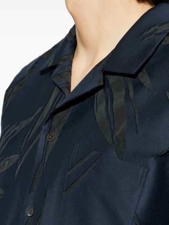 close up of blue shirts, showing texture of the cotton fabric