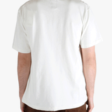 White t-shirt worn by a person, showing the t-shirt's fit