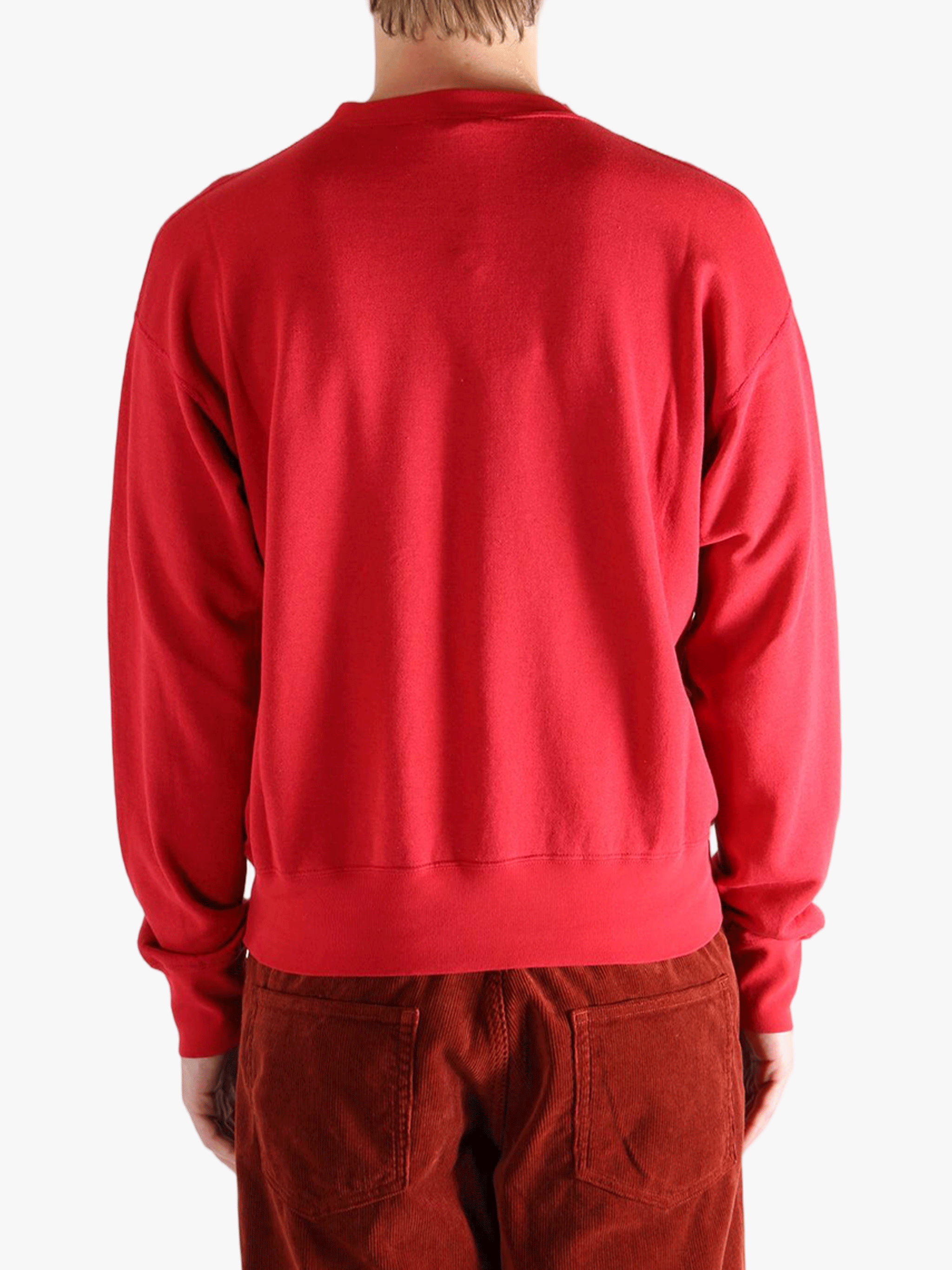 Red knitwear worn by a person, showing the knitwear's fit