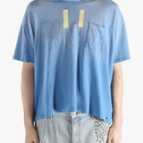 Blue t-shirt worn by a person, showing the shirt's fit