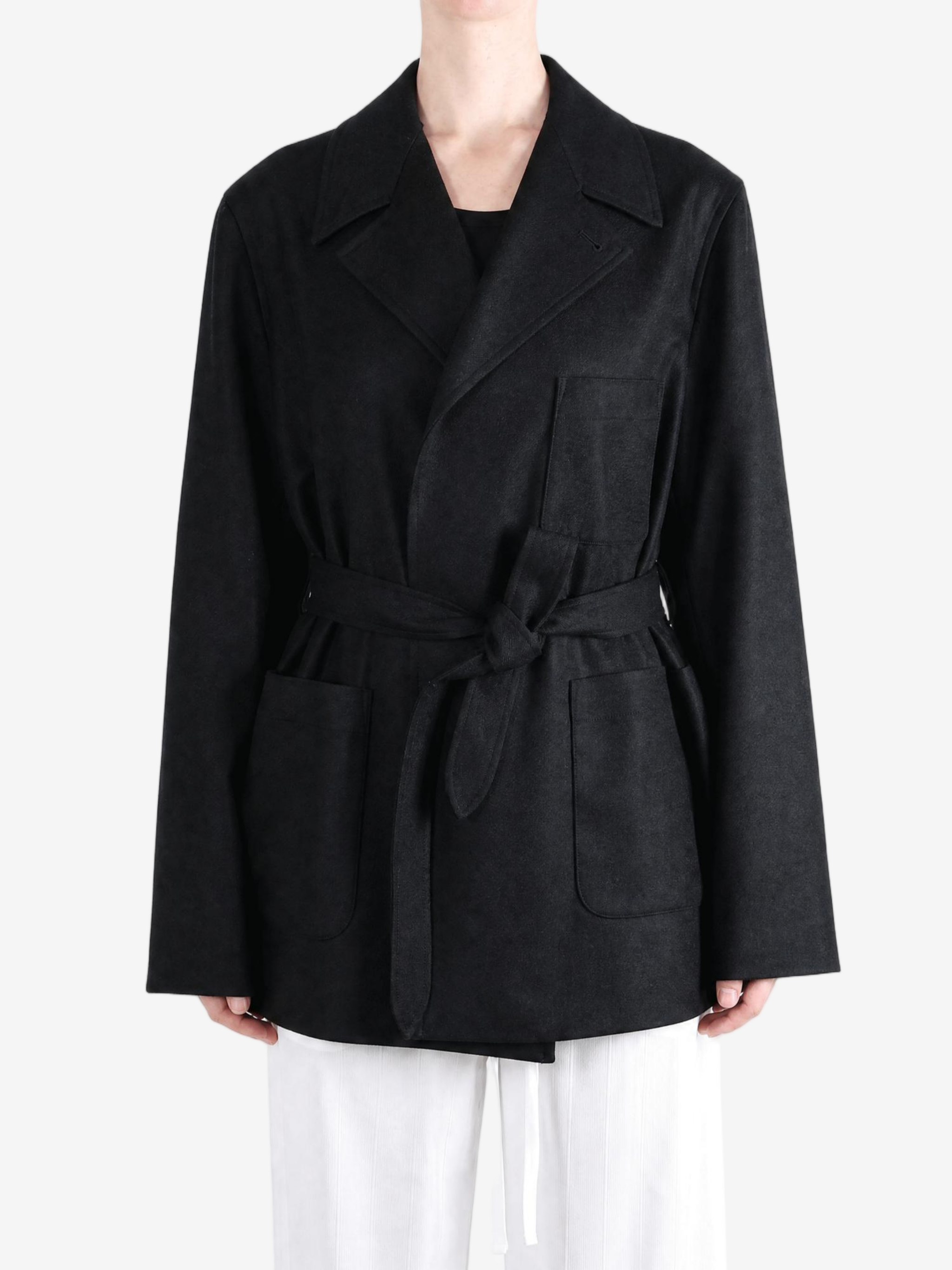 Black jacket worn by a person, showing the jacket fit