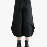 Black pants worn by a person, showing the pants's fit