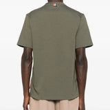 Green t-shirts worn by a person, showing the t-shirts fit