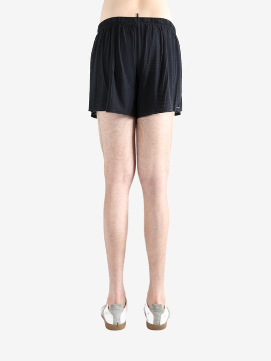 Black shorts worn by a person, showing the shorts' fit