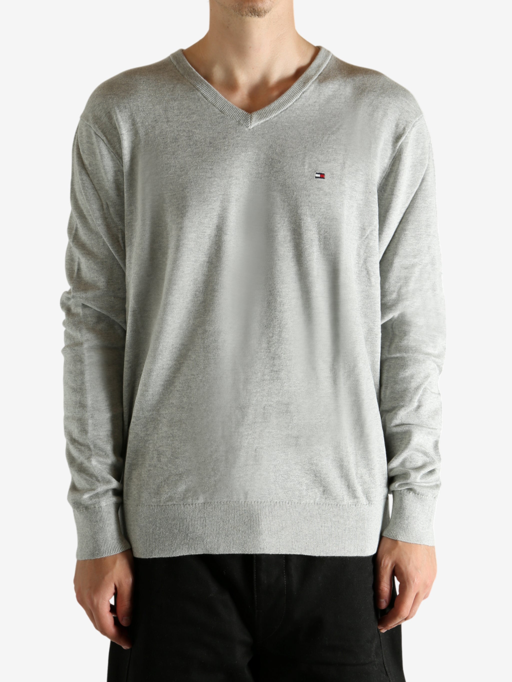 Grey sweater worn by a person, showing the sweater's fit