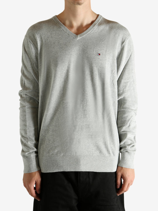 Grey sweater worn by a person, showing the sweater's fit