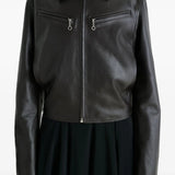 Close up of the brown jacket, showing texture of the leather fabric