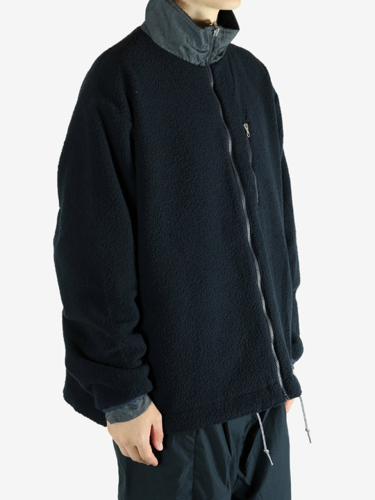 Navy jacket worn by a person, showing the jacket's fit