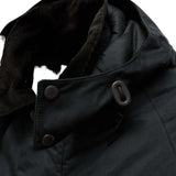 Close up of Black jacket, showing texture of the corduroy fabric