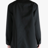 Black jacket worn by a person, showing the jackets fit