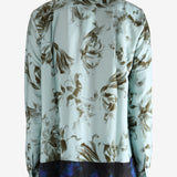 Green shirt worn by a person, showing the shirt's fit