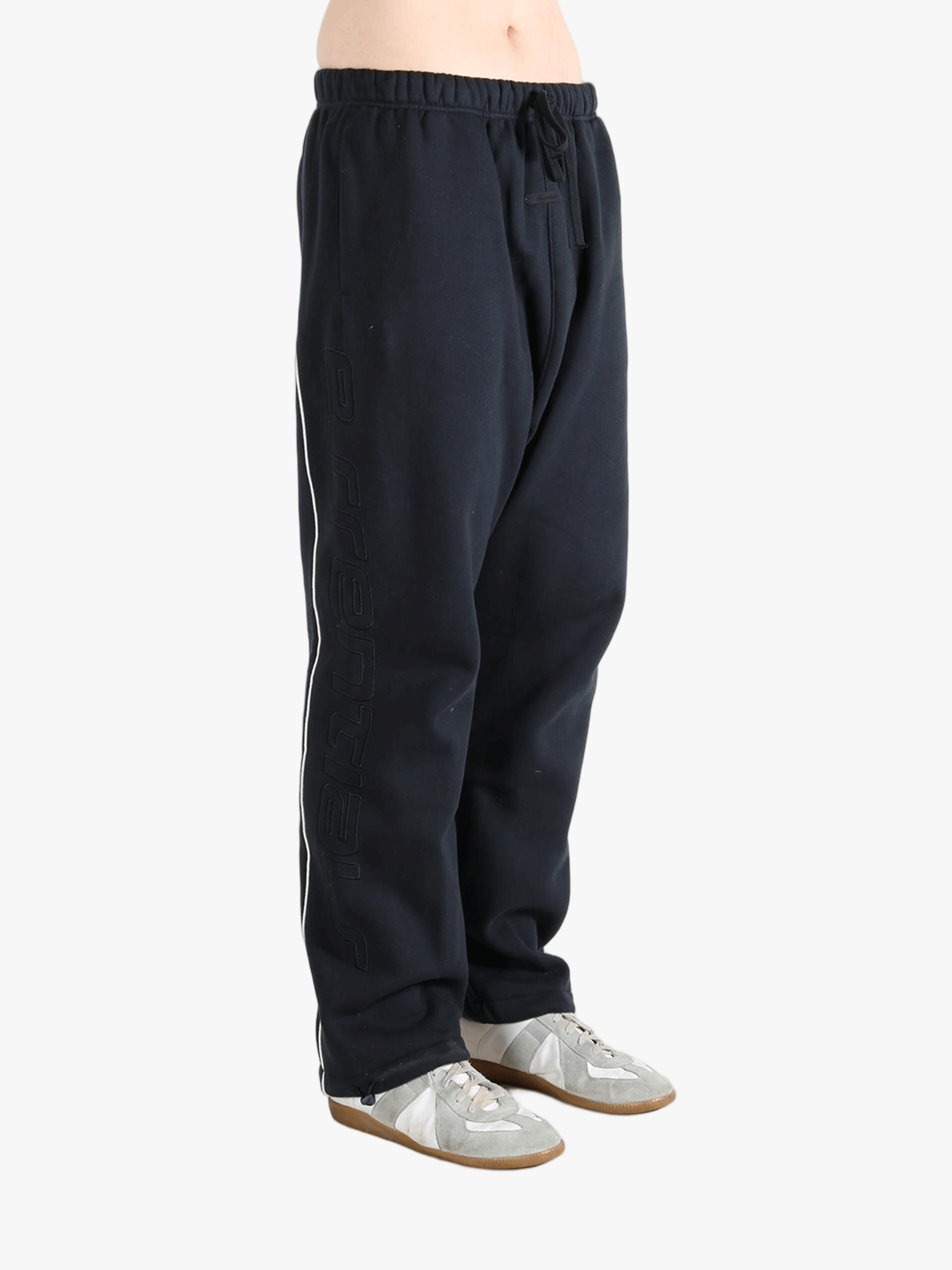 Black pants worn by a person, showing the pants fit
