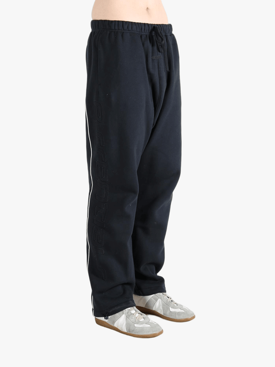 Black pants worn by a person, showing the pants fit