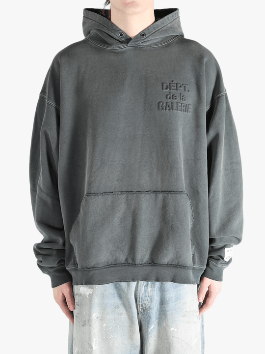 Grey hoodie worn by a person, showing the hoodie's fit