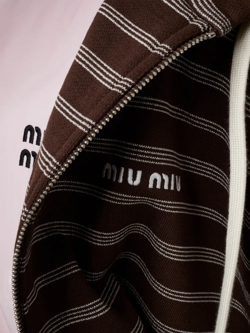 Close up of the brown hoodie, showing texture of the cotton fabric