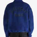 Blue jacket worn by a person, showing the jacket's fit