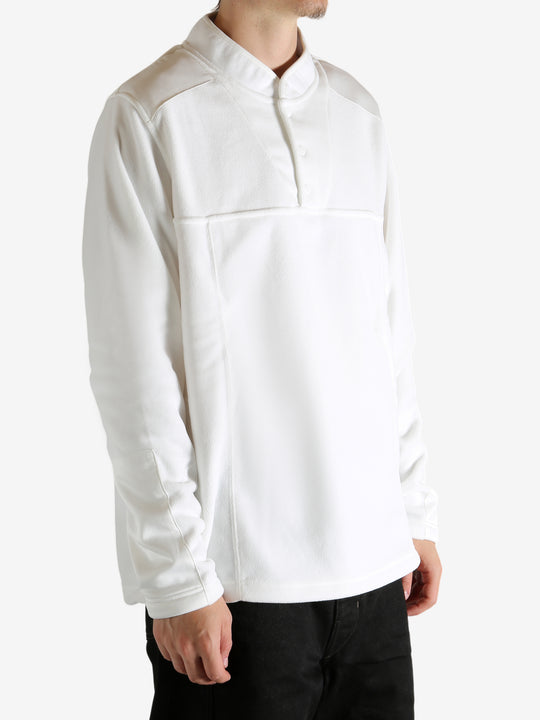 White sweatshirt worn by a person, showing the sweatshirt's fit
