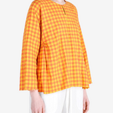 Orange shirt worn by a person, showing the shirt fit